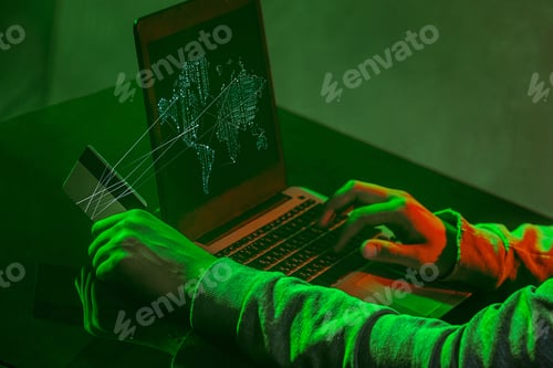 Preview: Hooded Computer Hacker Stealing Information With Laptop