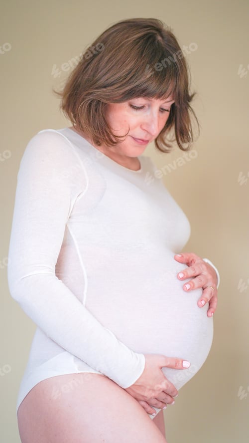 Preview: Close up of a woman Journey Through Pregnancy and Body Image. Maternity beautiful 9 month pregnancy