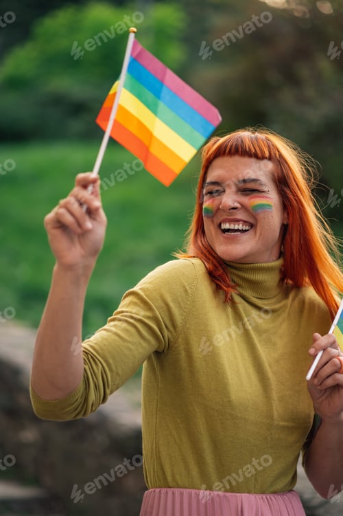 Preview: Happy activist waving rainbow flags at pride parade celebrating lgbtq plus rights