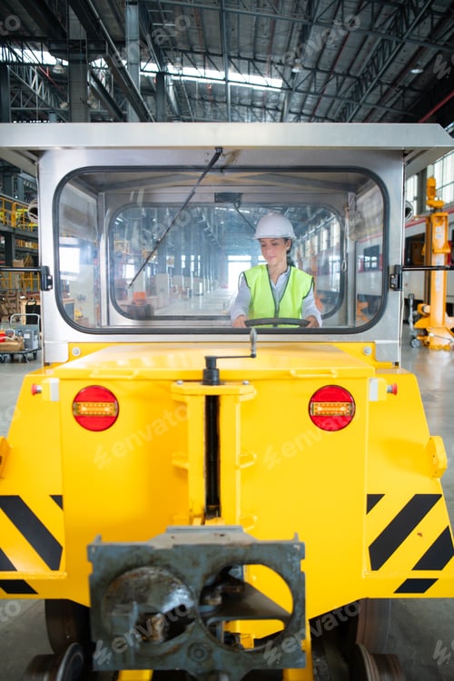 Preview: Female engineer working in electric train repair shop,