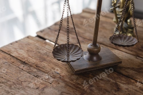 Preview: Justice scales balancing on rustic wooden table