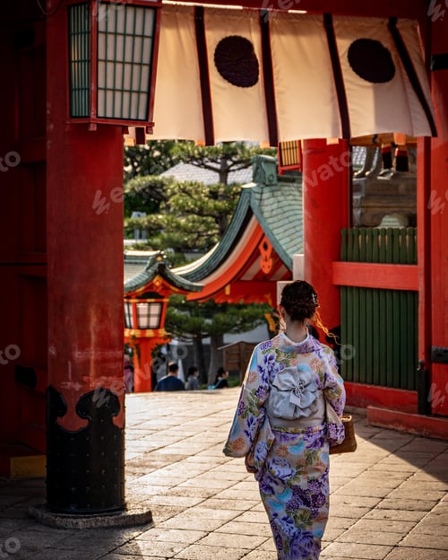 Preview: Young female strolling down an alleyway, with traditional Japanese tori gates