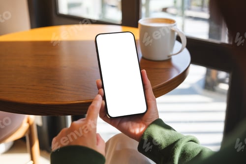 Preview: Mockup image of a woman holding mobile phone with blank desktop screen in cafe