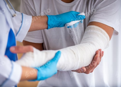 Preview: Doctor wrapping bandage on injured arm.