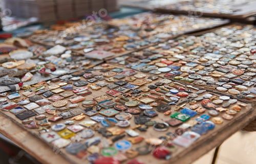 Preview: Selective focus of vintage badges for sale on street market.