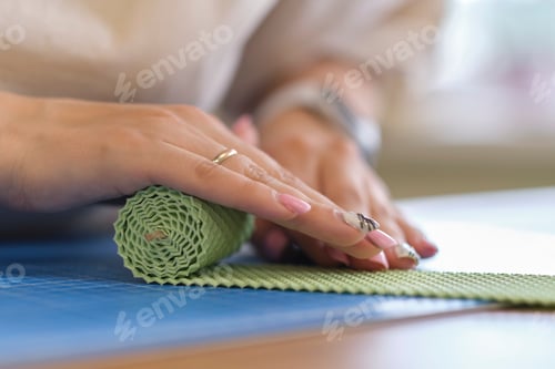 Preview: Hands Working with Green Protective Wrap Material