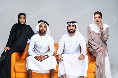 Preview: Beautiful arab middle-eastern friends with traditional emirate clothes at home