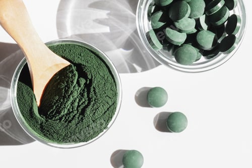 Preview: natural additives and superfood. green spirulina algae powder and pills in glass bowls