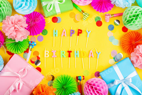 Preview: Flat lay with inscription happy birthday, gift boxes and holiday decorations on yellow background