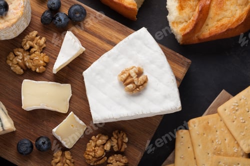 Preview: Tasting cheese dish on a wooden plate. Food for wine and romantic, cheese delicatessen