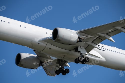 Preview: Modern commercial aircraft landing at international airport against blue sky showcases powerful jet