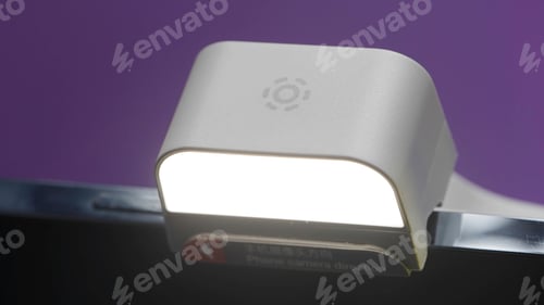 Preview: Close up of a portable flashlight on a smartphone device. Action. Photo or video shooting with a led