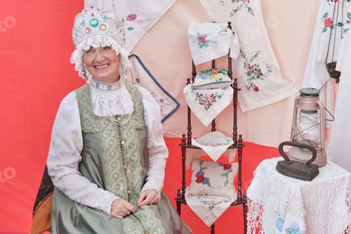 Preview: Smiling senior woman in stylized ancient Russian headdress - kokoshnik at rural holiday.