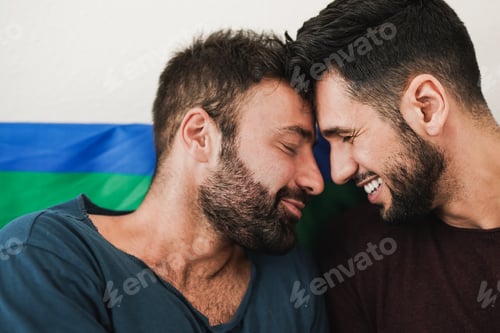 Preview: Young gay men couple having tender moment together at home