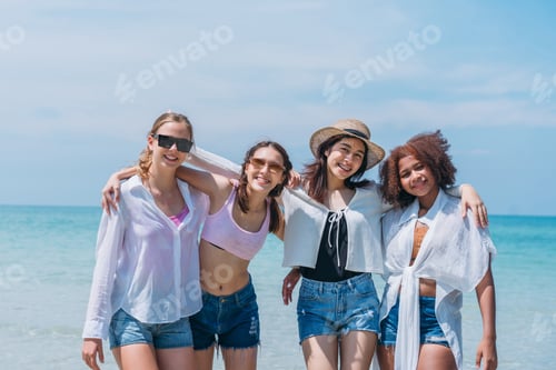 Preview: Happy children laughing and enjoying at beach. Teenage playing with friends at the sea.