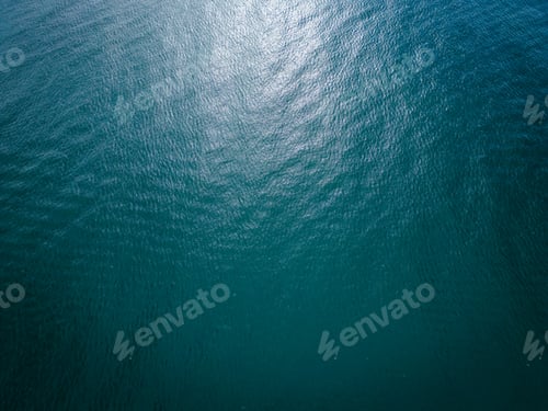 Preview: Aerial view of the sea surface reflecting the sun