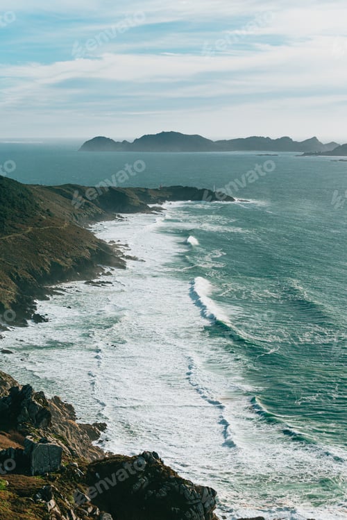 Preview: An aerial shot of a massive wild coast in spain with the waves crashing against it