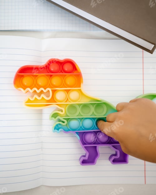 Preview: The child plays pop it instead of doing lessons.