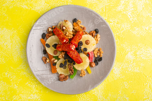 Preview: top view pineapple rings with nougat and dried fruits on the yellow background fruit dry snack photo