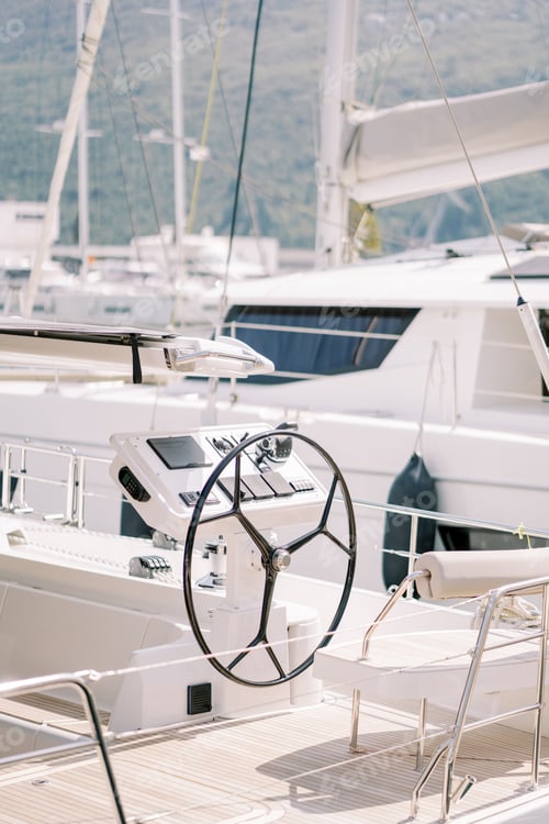 Preview: White leather seat with backrest at the helm of a yacht moored in the port