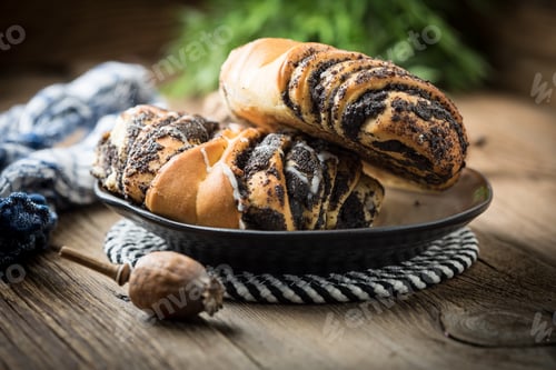 Preview: Sweet buns with poppy seed and frosting.