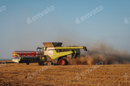 Preview: Agricultural machinery on the wheat field at daytime