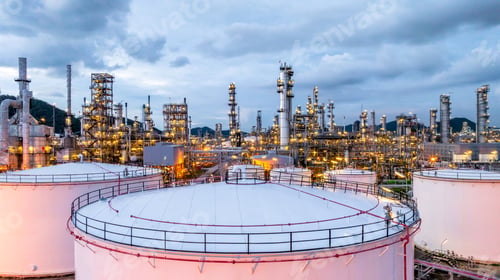 Preview: Oil refinery petrochemical plant at dusk illuminated storage tank industrial infrastructure