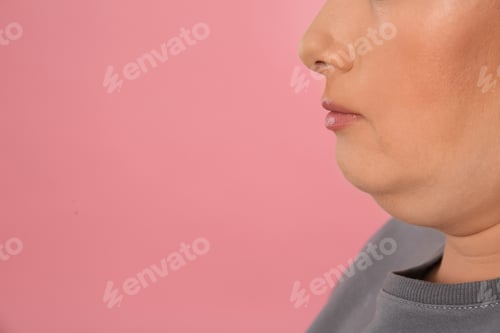 Preview: Woman with double chin on pink background, closeup. Space for text