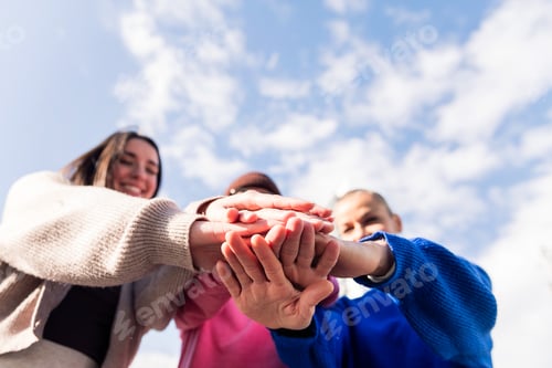 Preview: three happy friends holding hands in unity