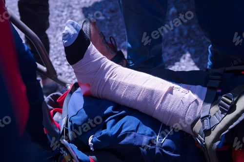 Preview: Mountain rescue service provide first aid to person with broken leg