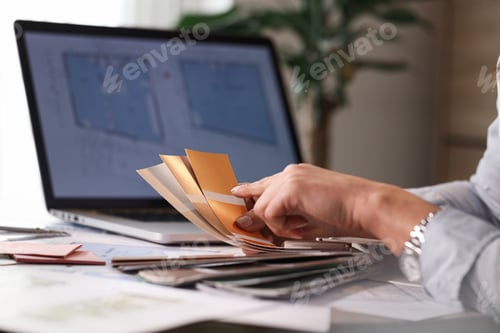 Preview: Close up of woman choosing color form palette while working on the office.