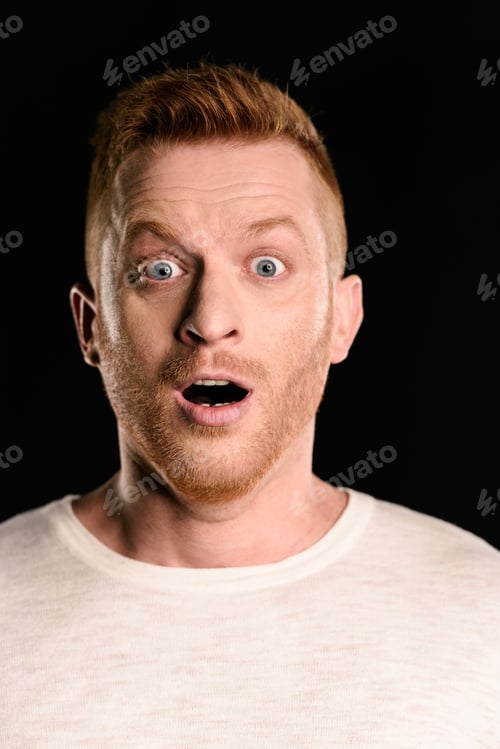 Preview: portrait of shocked handsome redhead man isolated on black