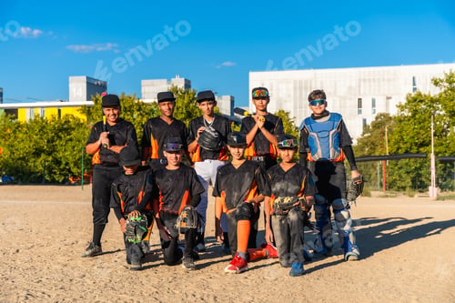 Preview: Youth baseball team posing on field after game