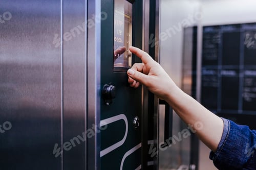 Preview: Hands of baker woman using oven machine in bakery