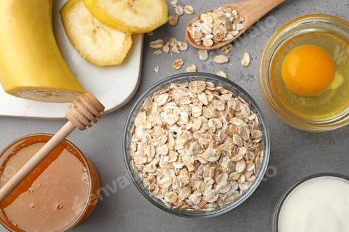 Preview: Different ingredients for handmade face mask on grey table, flat lay