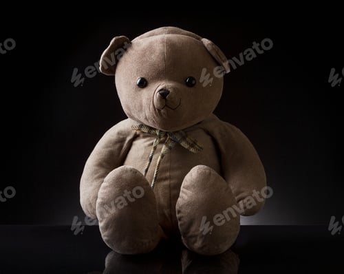Preview: Cute brown childhood teddy bear with black color in the background