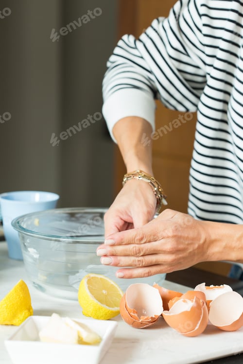 Preview: Woman hands greasing the baking dish while cooking apple pie