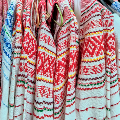 Preview: Traditional Russian folk bright patterns on woven clothes.Close-up