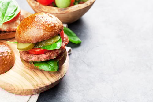 Preview: Tasty Hamburger with Tomato and Pickles on Table