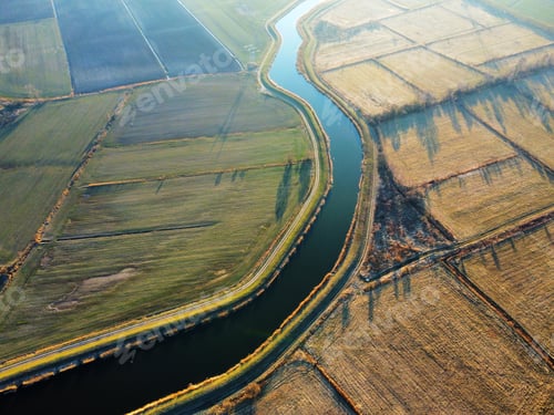 Preview: Drone shot of a river in a field