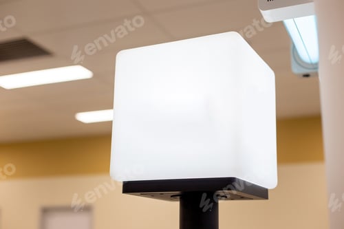 Preview: White empty light information cube on the counter, with a place for text