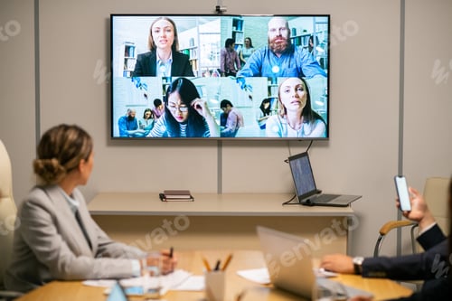 Preview: Several business people on large display hanging on wall of boardroom