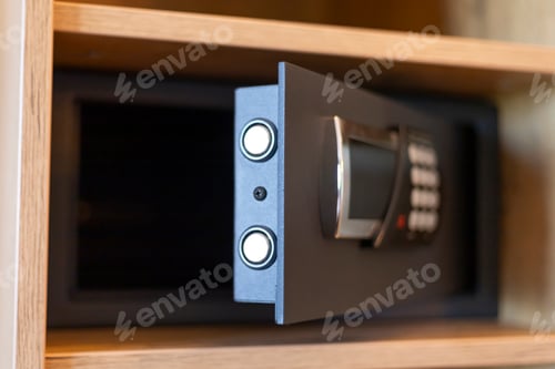 Preview: A secure safe with a digital keypad is partially open in a wooden cabinet