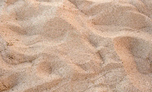 Preview: Flat view of clean yellow sand surface covering seaside beach. Sandy texture