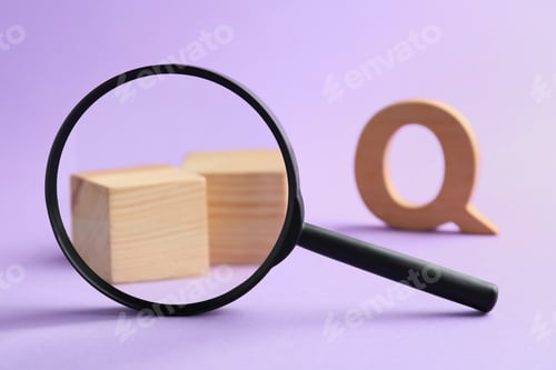 Preview: Magnifier glass, wooden cubes and letter Q on violet background, closeup. Find keywords concept