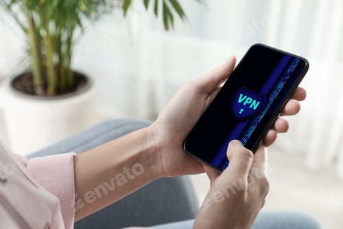 Preview: Woman using smartphone with switched on VPN indoors, closeup
