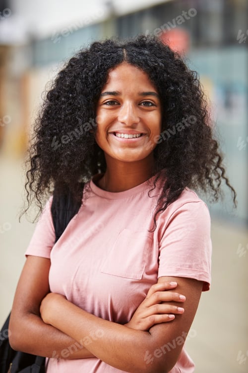 Preview: Portrait Of Female Student Standing In College Building