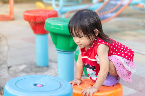 Preview: Happy Asian child girl playing and climbing with the toys at the playground