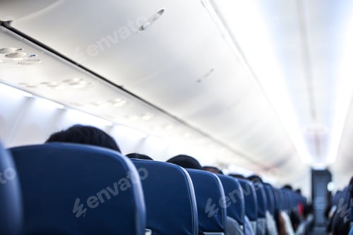Preview: Passengers traveling by a plane, shot from the inside of an airplane