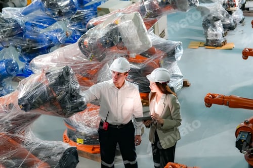 Preview: Indusrtial Robot technology, Engineers inspecting stock of welding robots at factory.